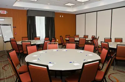 a conference room with tables and chairs in it at Holiday Inn Express & Suites Columbus - Easton Area by IHG in Gahanna