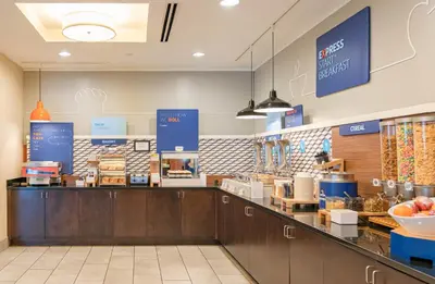 a fast food restaurant with a counter with food at Holiday Inn Express & Suites Columbus - Easton Area by IHG in Gahanna