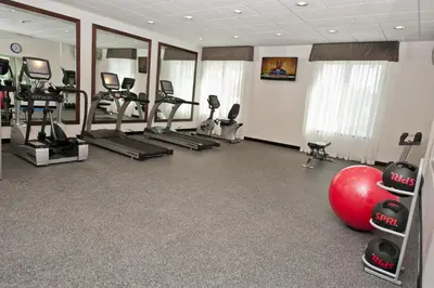 a gym with a lot of treadmills and exercise equipment at Holiday Inn Express & Suites Columbus - Easton Area by IHG in Gahanna