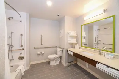 a bathroom with a sink and a toilet and a mirror at Hampton Inn & Suites Cincinnati Liberty Township in West Chester