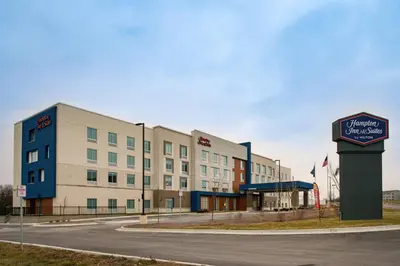 a hotel building with a sign in front of it at Hampton Inn & Suites Adrian, Mi in Adrian