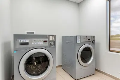 two washing machines sitting next to each other in a laundry room at Comfort Suites Dry Ridge in Dry Ridge