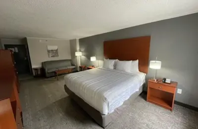 a hotel room with a bed and a couch at Best Western Lexington Inn in Lexington