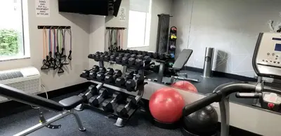 a fitness room with a gym with dumbbell equipment at Best Western Lexington Inn in Lexington