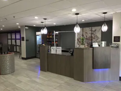 a lobby with a reception counter and pendant lights at Best Western Lexington Inn in Lexington