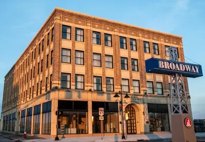 a brick building with a street sign in front of it at Ariel Broadway Hotel in Lorain
