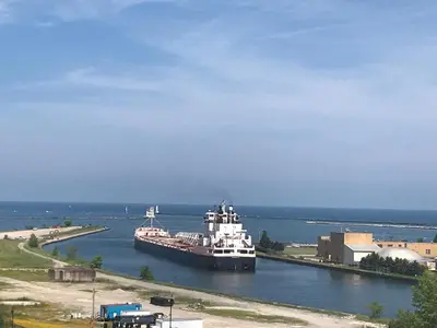 a large ferry boat in a large body of water at Ariel Broadway Hotel in Lorain