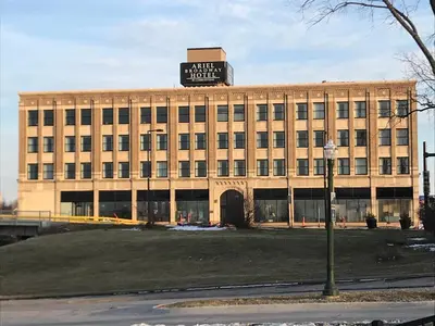 a large building with a sign on top of it at Ariel Broadway Hotel in Lorain