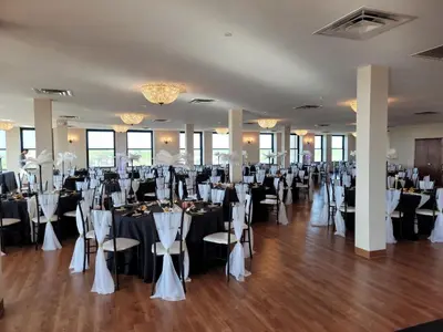 a banquet hall with tables and chairs in a room at Ariel Broadway Hotel in Lorain