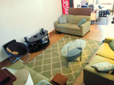 a living room with a couch and a fire place at The Wayfaring Buckeye Hostel in Columbus