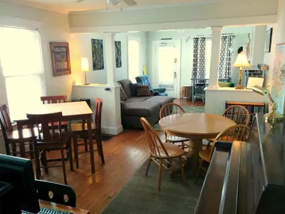a living room with a couch and a table and chairs at The Wayfaring Buckeye Hostel in Columbus