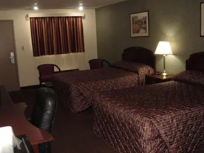 a hotel room with two beds and a window at German Village Inn Motel in Columbus