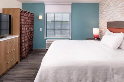 a hotel room with a large bed and a television at Home2 Suites By Hilton Columbus/West, OH in Columbus