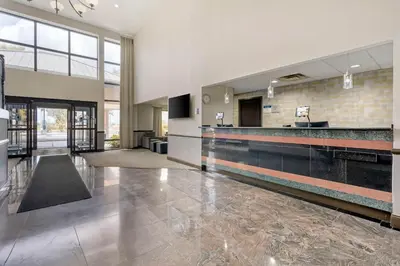 a lobby of a building with a reception counter at Best Western Suites Columbus in Columbus