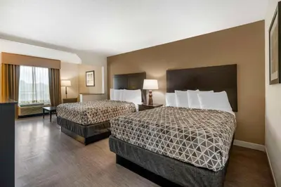 a hotel room with two beds and a window at Best Western Suites Columbus in Columbus