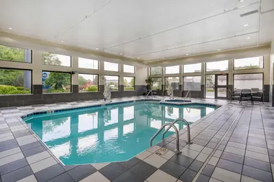 a large swimming pool in a building with windows at Best Western Suites Columbus in Columbus