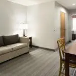 a living room with a couch and a table at Country Inn & Suites by Radisson, Columbus West, OH in Columbus