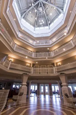 a large room with chairs and a ceiling at Cedar Point Hotel Breakers in Sandusky