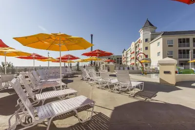 a group of chairs and umbrellas on a patio at Cedar Point Hotel Breakers in Sandusky
