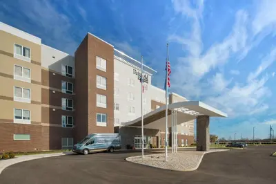 a building with a van parked in front of it at Fairfield Inn & Suites Columbus New Albany in New Albany