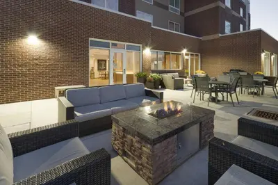 a patio with a blue couch and a fireplace at Fairfield Inn & Suites Columbus New Albany in New Albany