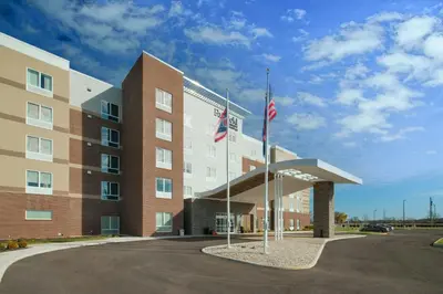 an exterior view of a hotel with two flags at Fairfield Inn & Suites Columbus New Albany in New Albany