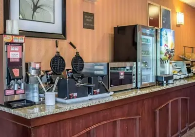 a bar in a restaurant with a counter with machines at Howard Johnson by Wyndham Columbus State Fairgrounds I-71 in Columbus