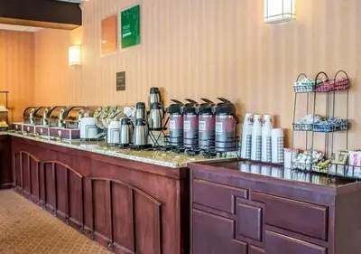 a restaurant with a counter with aasteryasteryasteryasteryasteryasteryasteryasteryastery at Howard Johnson by Wyndham Columbus State Fairgrounds I-71 in Columbus