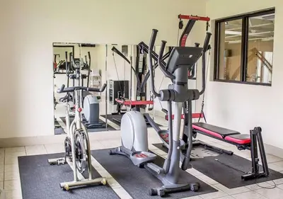 a gym with several exercise bikes and a mirror at Howard Johnson by Wyndham Columbus State Fairgrounds I-71 in Columbus