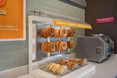 a bakery with donuts on display in a store at Tru By Hilton Monroe, MI in Monroe