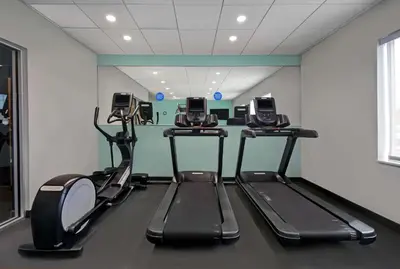 a gym with three exercise bikes in a room at Tru By Hilton Monroe, MI in Monroe