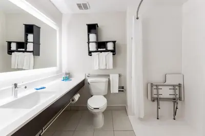 a bathroom with a toilet and a sink and a mirror at Holiday Inn Express - Columbus Downtown by IHG in Columbus