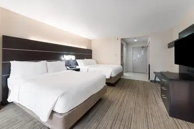 a hotel room with two beds and a flat screen tv at Holiday Inn Express - Columbus Downtown by IHG in Columbus