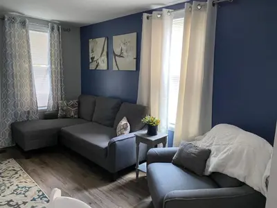 a blue living room with a couch and a chair at Cozy One Bedroom House in Adrian