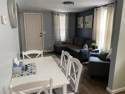 a living room with a table and chairs and a couch at Cozy One Bedroom House in Adrian