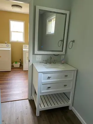 a bathroom with a white sink and a mirror at Cozy One Bedroom House in Adrian