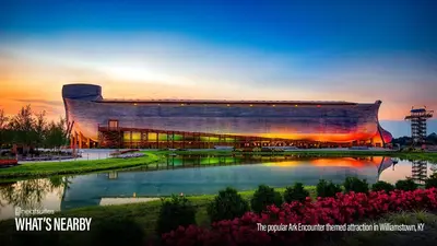 a large building with a lake in front of it at Open Concept Cabin for 2 - Near Ark Encounter! in Williamstown