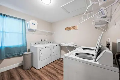 a laundry room with a washer and dryer at Spacious 6BR Near Ark! Ample Parking, 3 Full Baths in Williamstown