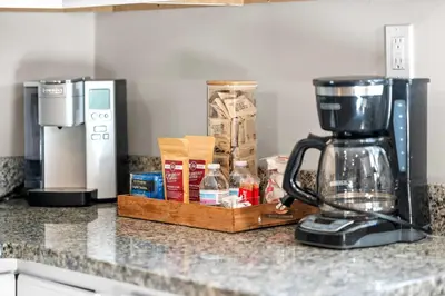 a kitchen counter with a coffee maker on a counter top at Spacious 6BR Near Ark! Ample Parking, 3 Full Baths in Williamstown
