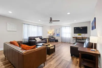 a living room with couches and a flat screen tv at Spacious 6BR Near Ark! Ample Parking, 3 Full Baths in Williamstown