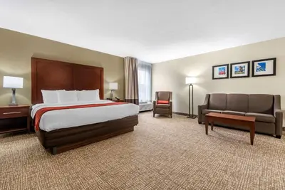 a large hotel room with a bed and a couch at Comfort Inn & Suites Cincinnati Eastgate in Eastgate