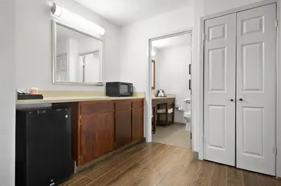 a bathroom with a counter and a sink and a toilet at Comfort Inn & Suites Cincinnati Eastgate in Eastgate