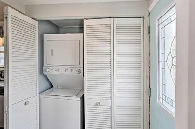 a white kitchen with a refrigerator and a microwave at Waterfront Oak Harbor Home on Lake Erie with Views! in Sand Beach