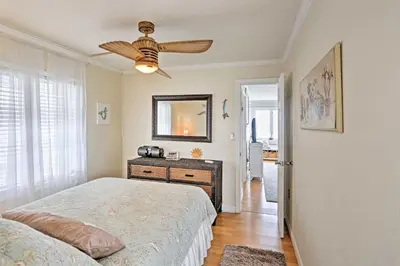 a bedroom with a bed and a ceiling fan at Waterfront Oak Harbor Home on Lake Erie with Views! in Sand Beach
