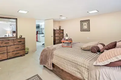 a bedroom with a large bed and a dresser at Contemporary Cincinnati Apt with WiFi, Near Kenwood! in Cincinnati