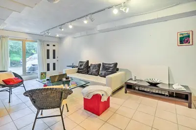 a living room with a couch and a table at Contemporary Cincinnati Apt with WiFi, Near Kenwood! in Cincinnati