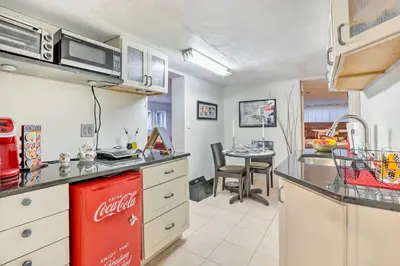 a kitchen with an old coca cola refrigerator at Contemporary Cincinnati Apt with WiFi, Near Kenwood! in Cincinnati