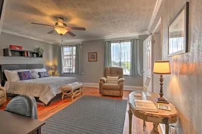 a bedroom with a bed and a table and a chair at 2 Mi to Ark Encounter Updated Williamstown Apt! in Williamstown