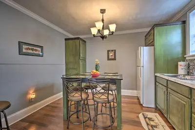a kitchen with a green island with stools at 2 Mi to Ark Encounter Updated Williamstown Apt! in Williamstown