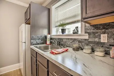 a kitchen with a sink and a refrigerator at Modern Studio Apartment in Central Williamstown! in Williamstown
